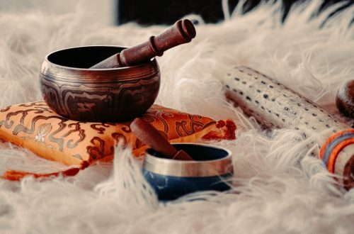 brown wooden mortar and pestle on white textile