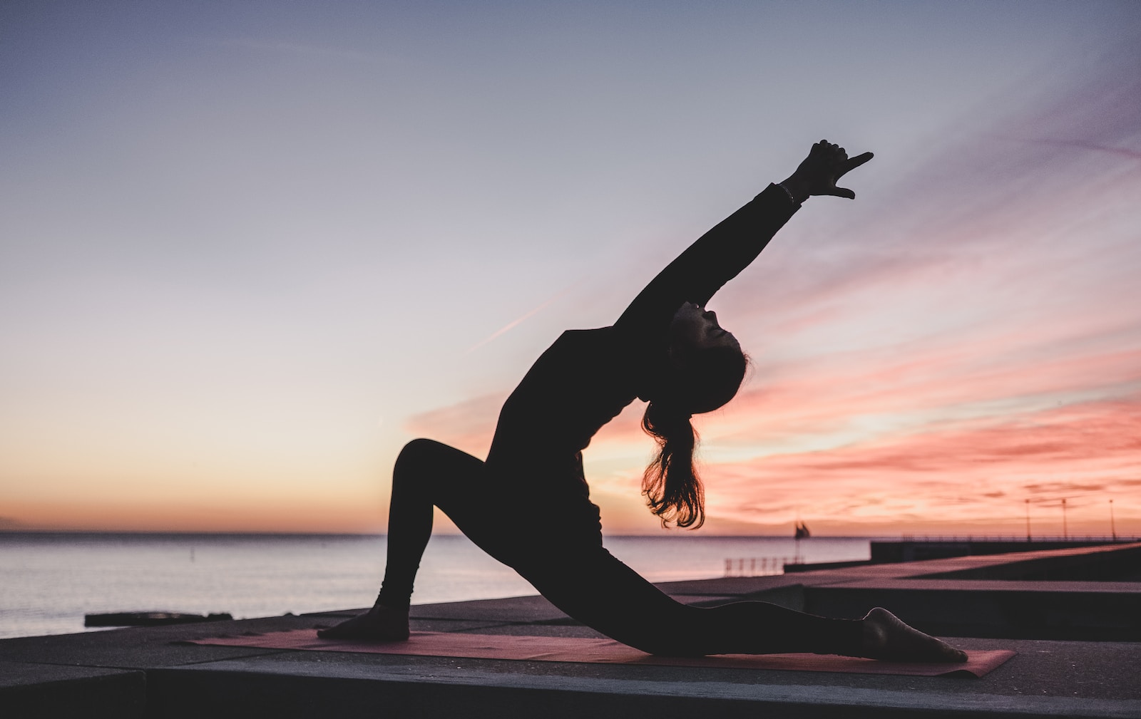 silhouette photography of woman doing yoga sophie